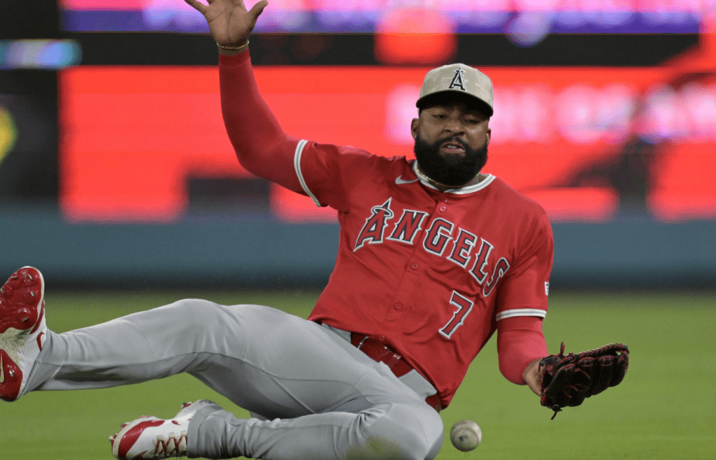 May 16, 2025; Los Angeles, California, USA; Los Angeles Angels right fielder Jo Adell (7) attempts a sliding catch off a pop up by Los Angeles Dodgers catcher Will Smith (16) in the ninth inning at Dodger Stadium. Mandatory Credit: Jayne Kamin-Oncea-Imagn Images