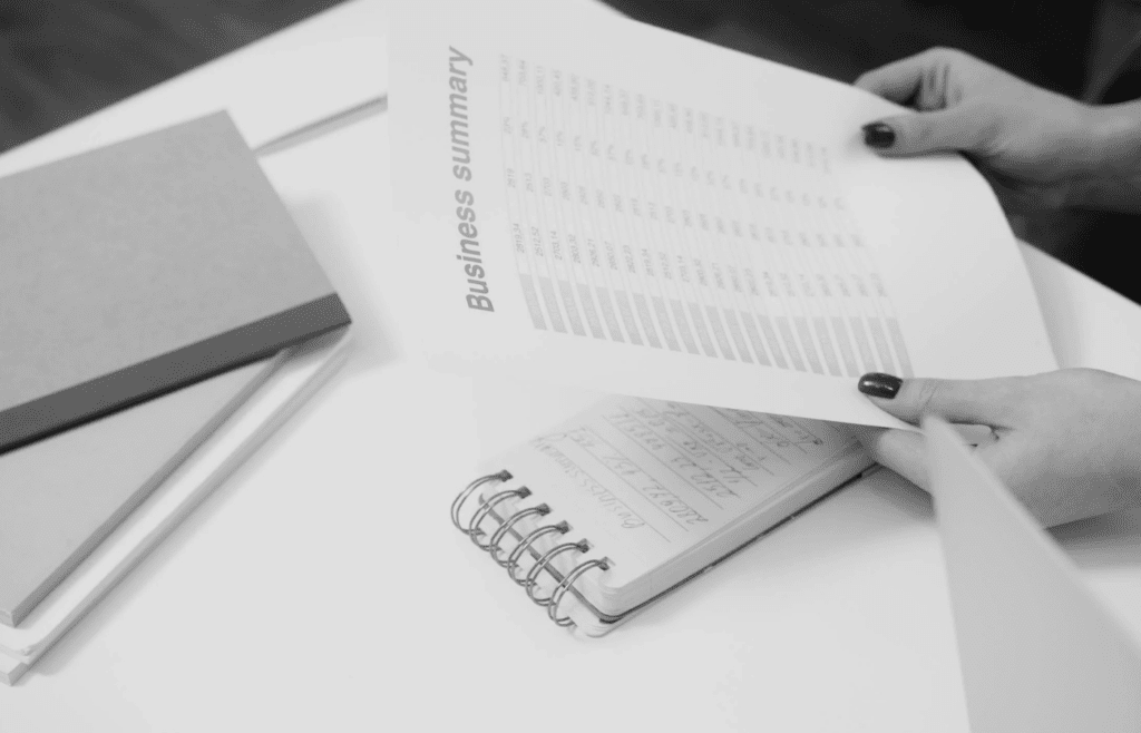 A person surrounded by financial charts and books