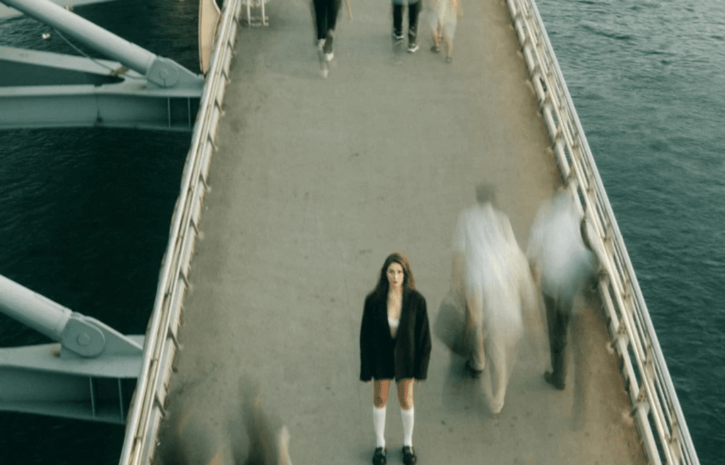 A person alone in a crowd, pretending not to care