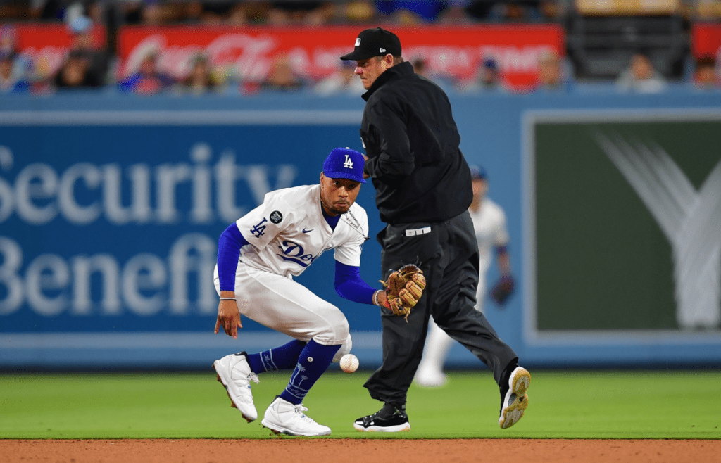 May 19, 2025; Los Angeles, California, USA; Los Angeles Dodgers shortstop Mookie Betts (50) fields the ground ball of Arizona Diamondbacks catcher Gabriel Moreno (14) during the seventh inning at Dodger Stadium. Mandatory Credit: Gary A. Vasquez-Imagn Images