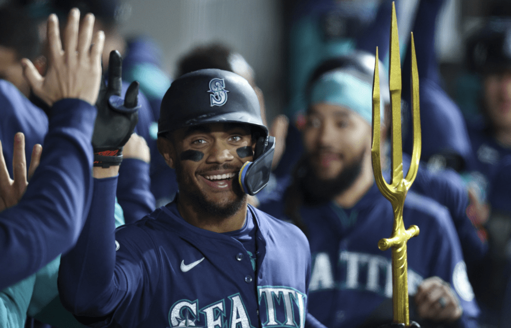 May 19, 2025; Chicago, Illinois, USA; Seattle Mariners center fielder Julio Rodríguez (44) celebrates with teammates in the dugout after hitting a grand slam against the Chicago White Sox during the eight inning at Rate Field. Mandatory Credit: Kamil Krzaczynski-Imagn Images