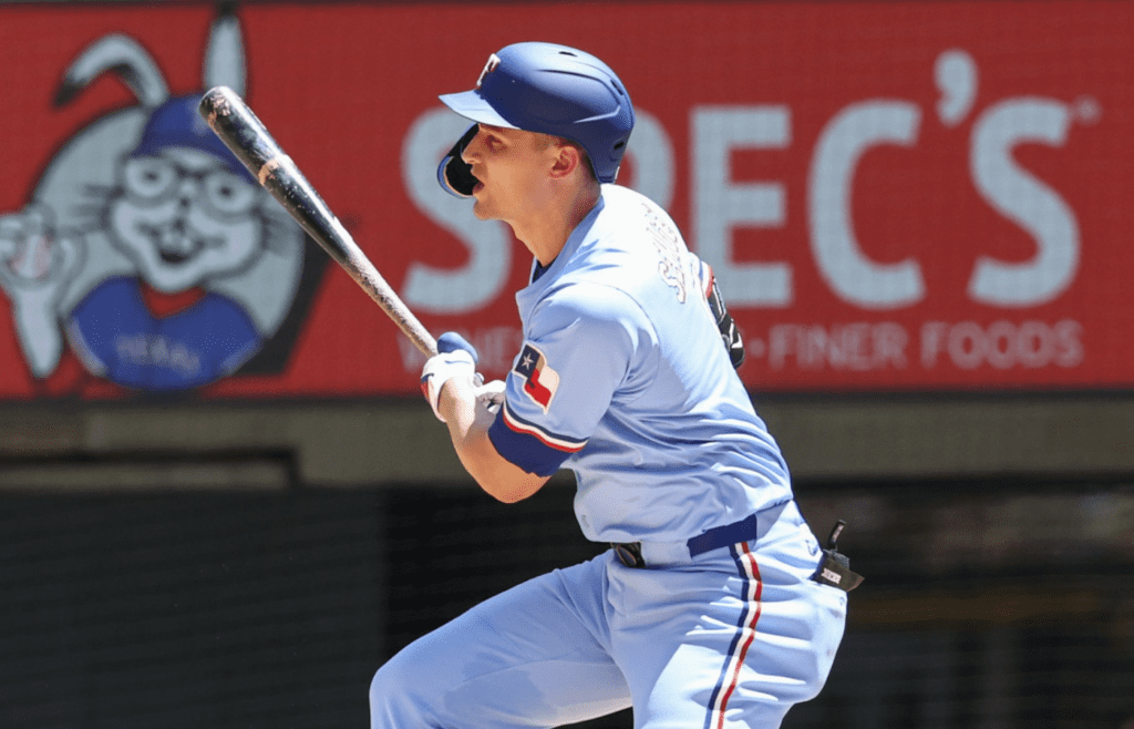 May 4, 2025; Arlington, Texas, USA; Texas Rangers shortstop Corey Seager (5) hits a two-run single during the third inning against the Seattle Mariners at Globe Life Field. Mandatory Credit: Kevin Jairaj-Imagn Images