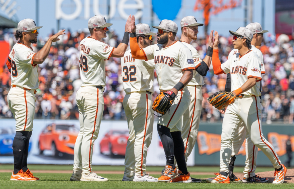 May 18, 2025; San Francisco, California, USA; San Francisco Giants outfielder Heliot Ramos (17) and San Francisco Giants outfielder Jung Hoo Lee (51) celebrate with their teammates after the game against the Oakland Athletics at Oracle Park. Mandatory Credit: Bob Kupbens-Imagn Images