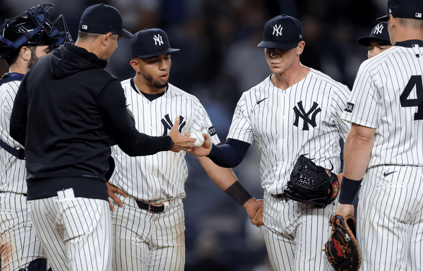 May 20, 2025; Bronx, New York, USA; New York Yankees manager Aaron Boone (17) takes the ball from relief pitcher Ian Hamilton (71) during a pitching change during the ninth inning against the Texas Rangers at Yankee Stadium. Mandatory Credit: Brad Penner-Imagn Images
