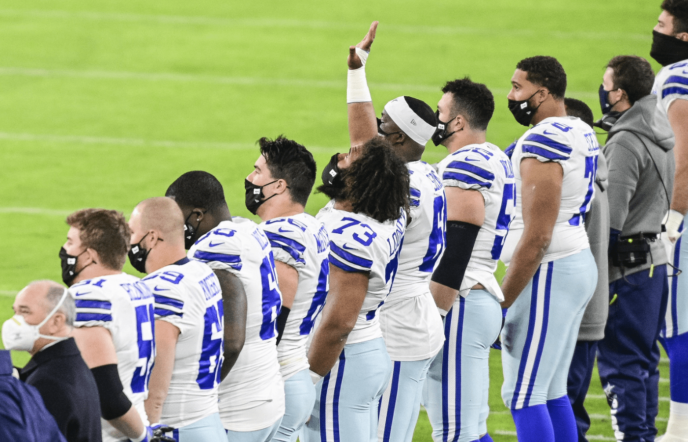 Dec 8, 2020; Baltimore, Maryland, USA; Dallas Cowboys center Joe Looney (73) points towards the sky while standing with his teammates during the playing of the national anthem before the game against the Baltimore Ravens at M&T Bank Stadium. Mandatory Credit: Tommy Gilligan-Imagn Images