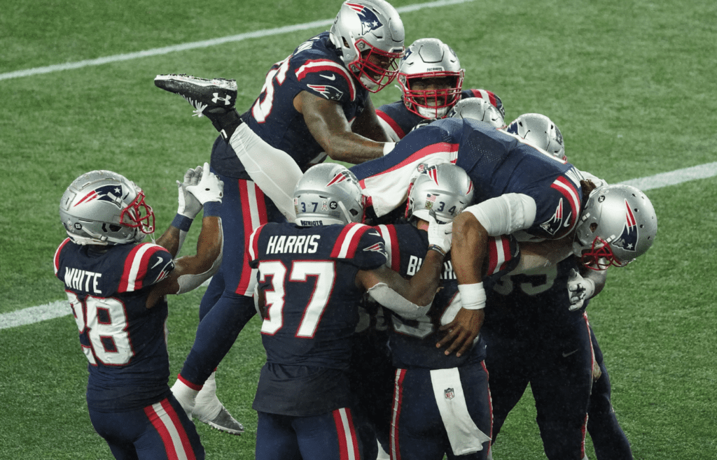 Nov 15, 2020; Foxborough, Massachusetts, USA; New England Patriots quarterback Cam Newton (1) celebrates a touchdown by running back Rex Burkhead (34) against Baltimore Ravens during the second quarter at Gillette Stadium. Mandatory Credit: David Butler II-Imagn Images