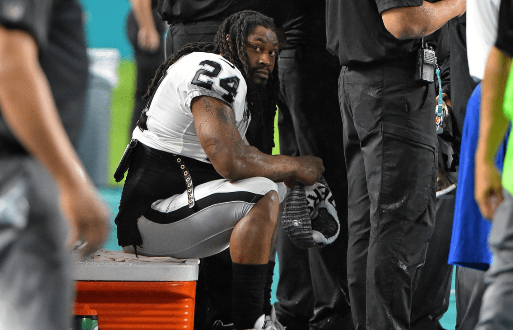 Nov 5, 2017; Miami Gardens, FL, USA; Oakland Raiders running back Marshawn Lynch (24) sits on a cooler during the National Anthem prior to the game against the Miami Dolphins at Hard Rock Stadium. Mandatory Credit: Jasen Vinlove-Imagn Images