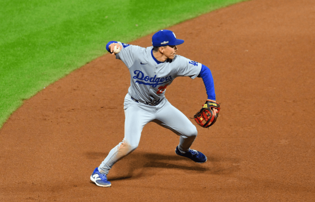 Oct 16, 2024; New York City, New York, USA; Los Angeles Dodgers outfielder Tommy Edman (25) makes a throws to first base against the New York Mets in the fourth inning during game three of the NLCS for the 2024 MLB playoffs at Citi Field. Mandatory Credit: John Jones-Imagn Images