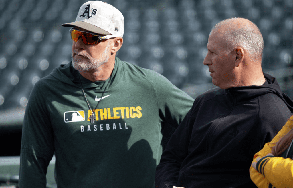 May 16, 2025; San Francisco, California, USA; Athletics manager Mark Kotsay (left) chats up team general manager David Forst before their game against the San Francisco Giants at Oracle Park. Mandatory Credit: D. Ross Cameron-Imagn Images