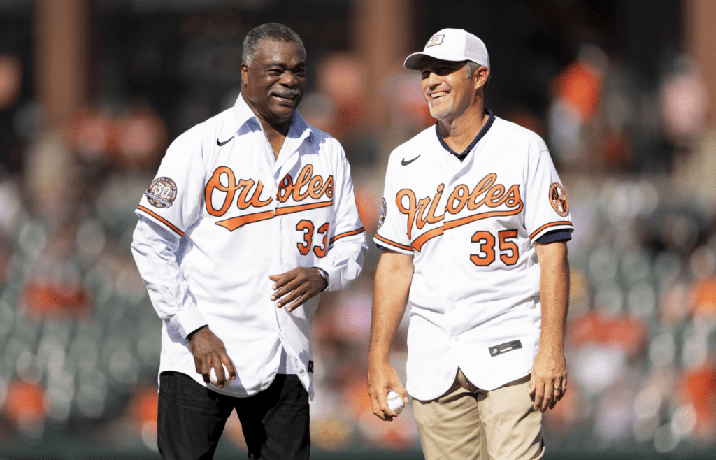 Aug 6, 2022; Baltimore, Maryland, USA; Baltimore Orioles Hall of Famers Eddie Murray (33) and Mike Mussina (35) smile just prior to throwing out the ceremonial first pitch at Oriole Park at Camden Yards. The Orioles were celebrating the 30th anniversary of Camden Yards. Mandatory Credit: Brent Skeen-Imagn Images