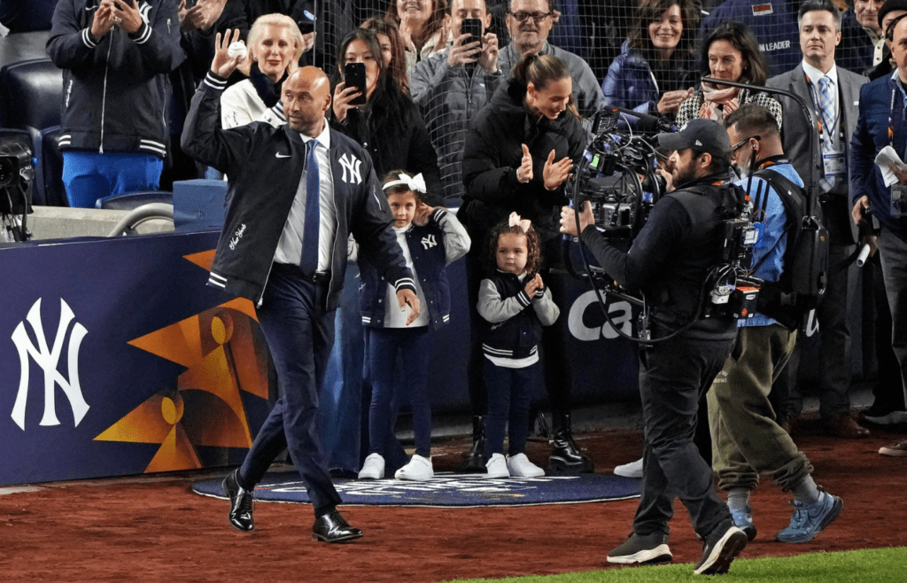 Oct 28, 2024; New York, New York, USA; New York Yankees former player Derek Jeter walks to the mound to throw out the ceremonial first pitch before game three of the 2024 MLB World Series between the New York Yankees and the Los Angeles Dodgers at Yankee Stadium. Mandatory Credit: Robert Deutsch-Imagn Images