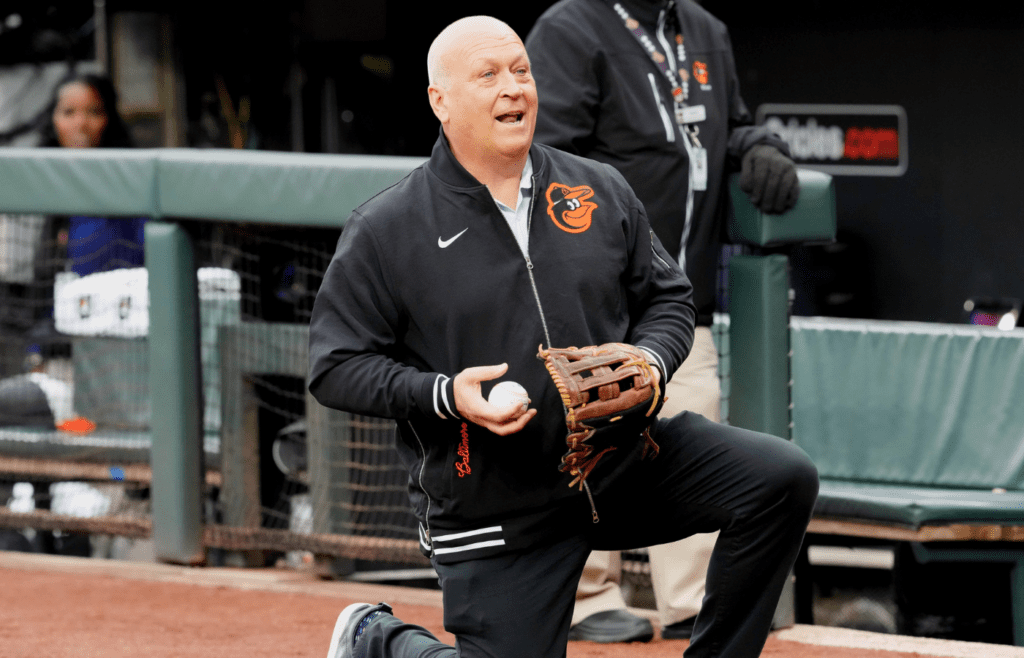 Mar 28, 2024; Baltimore, Maryland, USA; Baltimore Orioles legend Cal Ripken Jr warms up Aubree Singletary (not shown) before she threw out the pre-game ceremonial first pitch against the Los Angeles Angels at Oriole Park at Camden Yards. Mandatory Credit: Mitch Stringer-Imagn Images