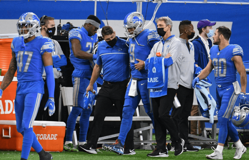 Dec 13, 2020; Detroit, Michigan, USA; Detroit Lions quarterback Matthew Stafford (9) talks to medical staff after an injury during the fourth quarter against the Green Bay Packers at Ford Field. Mandatory Credit: Tim Fuller-Imagn Images