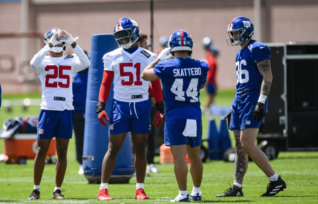 May 10, 2025; East Rutherford, NJ, USA; New York Giants cornerback Korie Black (25), linebacker Abdul Carter (51), running back Cam Skattebo (44) and tight end Thomas Fidone II (86) chat during rookie minicamp at Quest Diagnostics Training Center. Mandatory Credit: John Jones-Imagn Images