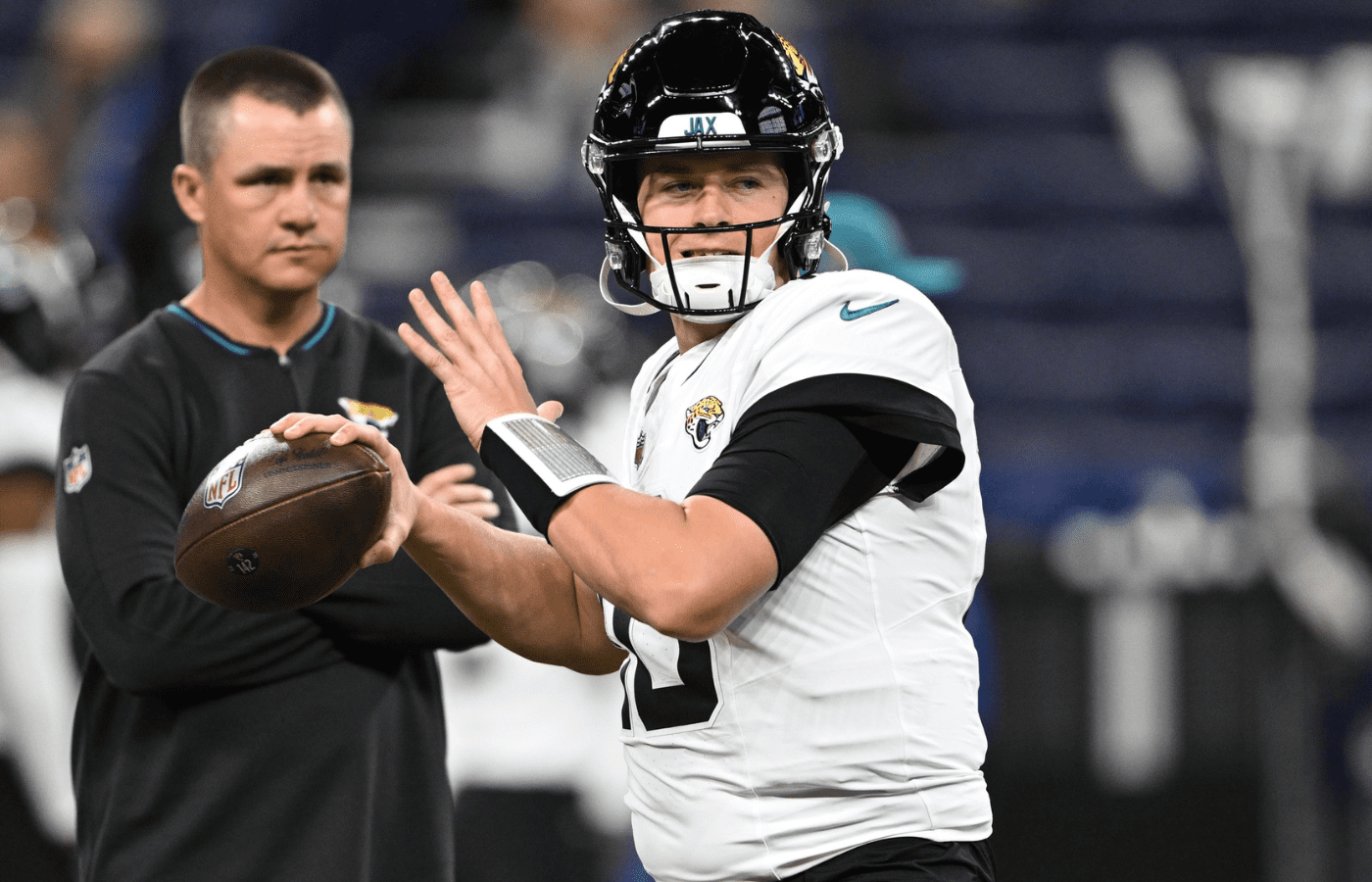 Jacksonville Jaguars quarterback Mac Jones (10) throws a pass to warm up before the game against the Indianapolis Colts at Lucas Oil Stadium.