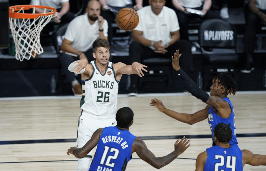Aug 20, 2020; Lake Buena Vista, Florida, USA; Milwaukee Bucks guard Kyle Korver (26) passes the ball against the Orlando Magic during the second half in game two of the first round of the 2020 NBA Playoffs at The Field House. Mandatory Credit: Ashley Landis/Pool Photo-Imagn Images