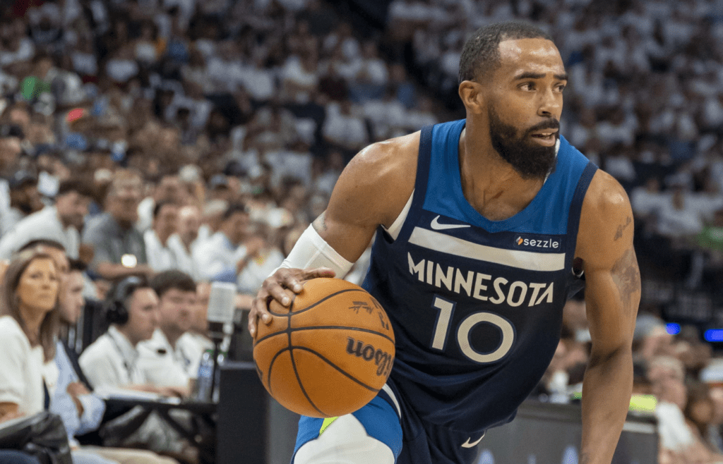 May 14, 2025; Minneapolis, Minnesota, USA; Minnesota Timberwolves guard Mike Conley (10) dribbles the ball against the Golden State Warriors in the first half during game five of the second round for the 2025 NBA Playoffs at Target Center. Mandatory Credit: Jesse Johnson-Imagn Images