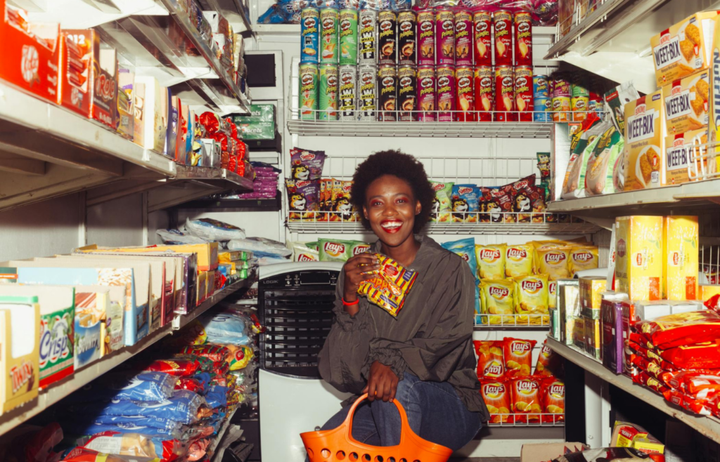Happy Woman Buying Groceries in a Convenience Store