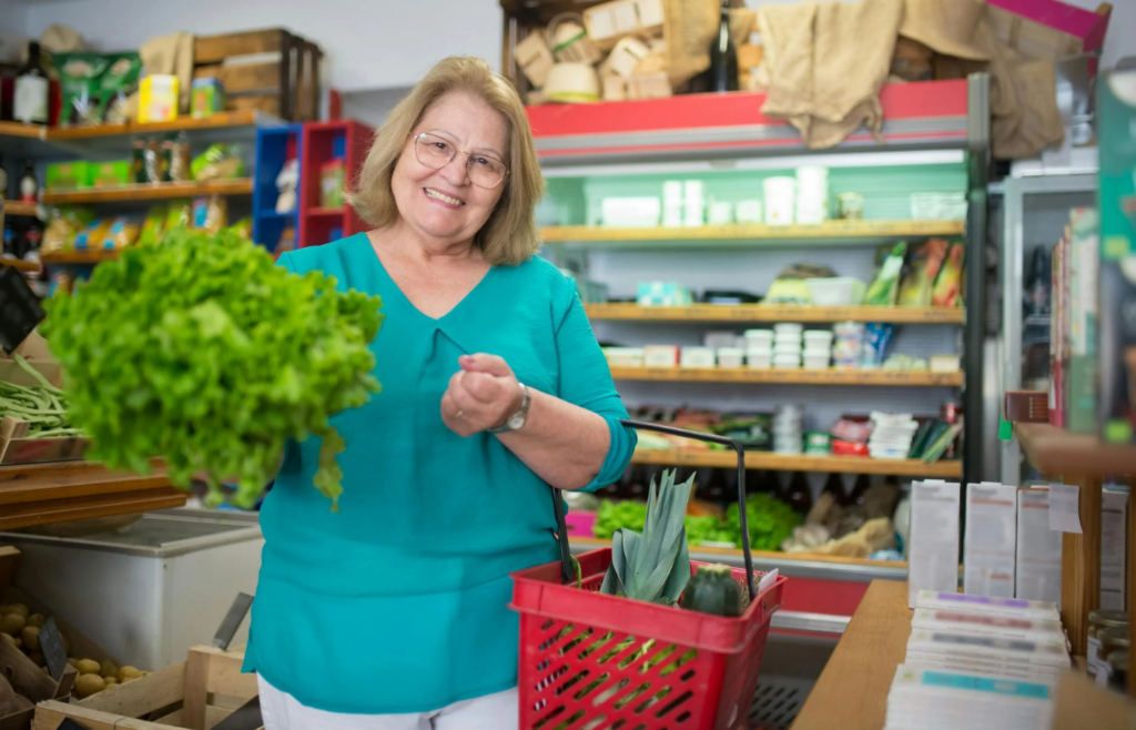 An Elderly Woman Smiling while Carrying a Basket