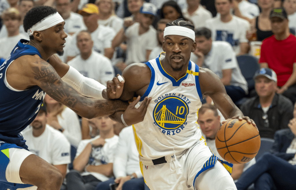 May 14, 2025; Minneapolis, Minnesota, USA; Golden State Warriors forward Jimmy Butler III (10) drives to the basket past Minnesota Timberwolves forward Jaden McDaniels (3) in the second half during game five of the second round for the 2025 NBA Playoffs at Target Center. Mandatory Credit: Jesse Johnson-Imagn Images