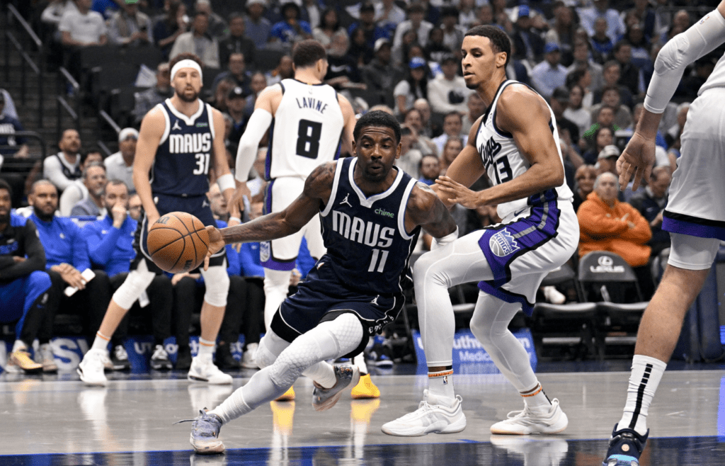 Mar 3, 2025; Dallas, Texas, USA; Dallas Mavericks guard Kyrie Irving (11) drives to the basket past Sacramento Kings forward Keegan Murray (13) during the first quarter at the American Airlines Center. Mandatory Credit: Jerome Miron-Imagn Images