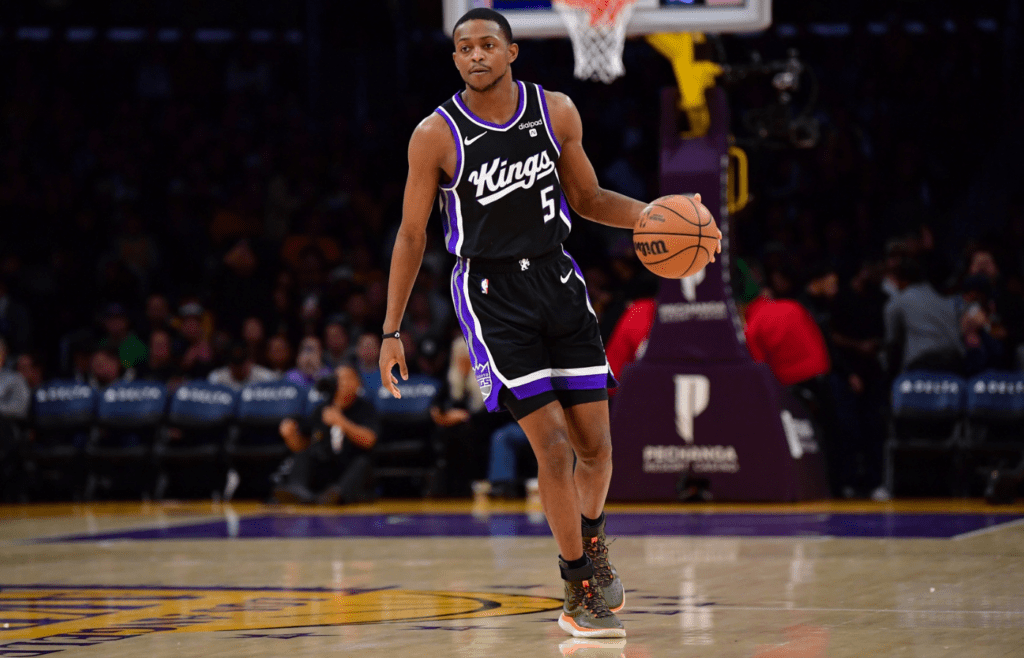Mar 6, 2024; Los Angeles, California, USA; Sacramento Kings guard De’Aaron Fox (5) controls the ball against the against the Los Angeles Lakers during the first half at Crypto.com Arena. Mandatory Credit: Gary A. Vasquez-Imagn Images