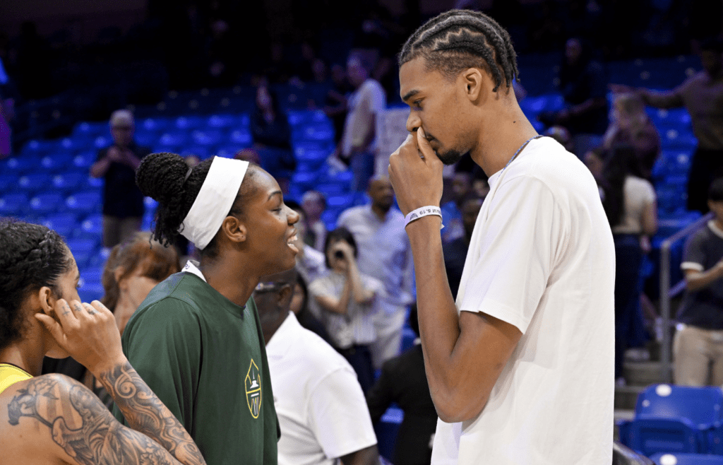 May 19, 2025; Arlington, Texas, USA; Seattle Storm center Dominique Malonga (left) talks with San Antonio Spurs forward Victor Wembanyama (right) after the game against the Dallas Wings at College Park Center. Mandatory Credit: Jerome