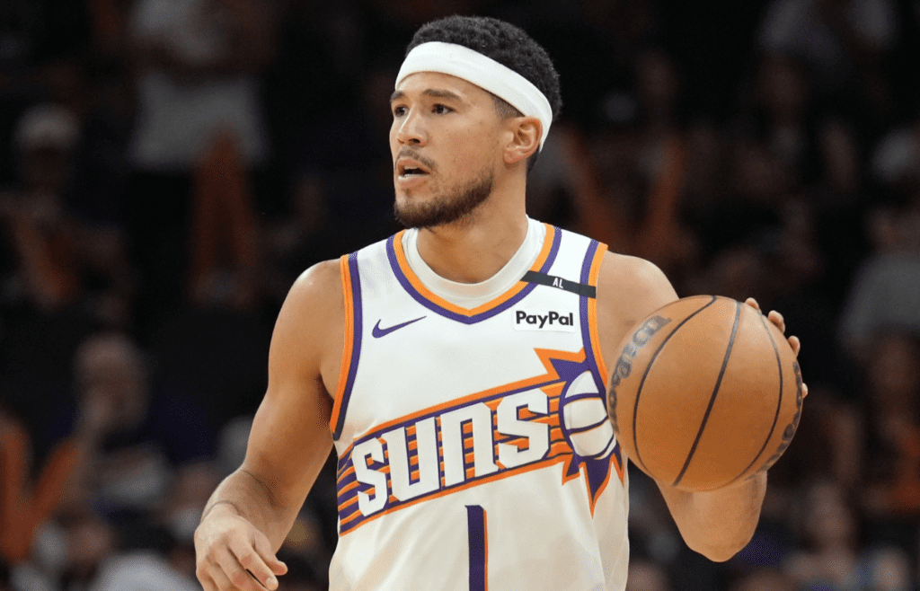 Apr 11, 2025; Phoenix, Arizona, USA; Phoenix Suns guard Devin Booker (1) dribbles against the San Antonio Spurs during the second half at Footprint Center. Mandatory Credit: Joe Camporeale-Imagn Images
