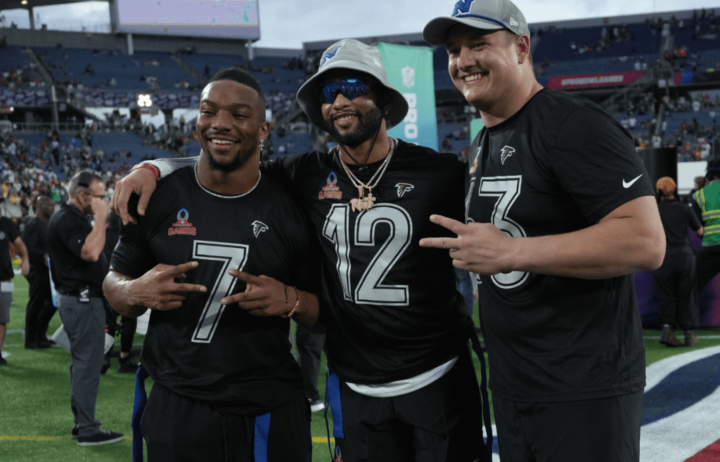 Feb 2, 2025; Orlando, FL, USA; Atlanta Falcons running back Bijan Robinson (7), special teams player KhaDarel Hodge (12) and guard Chris Lindstrom (63) pose during the 2025 Pro Bowl Games at Camping World Stadium. Mandatory Credit: Kirby Lee-Imagn Images