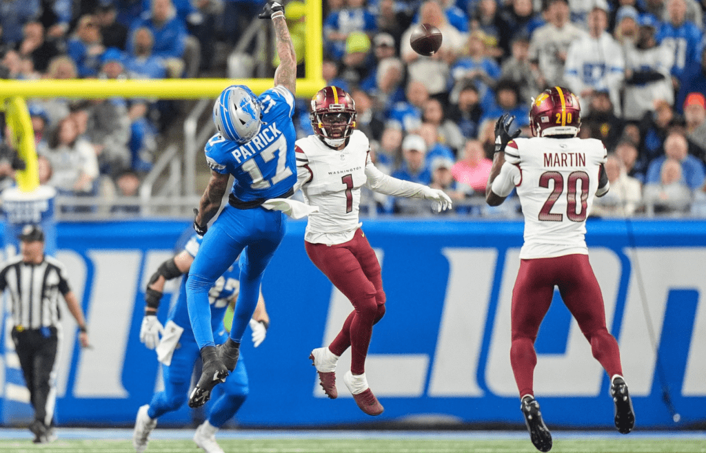 Washington Commanders safety Quan Martin intercepts a pass intended for Detroit Lions receiver Tim Patrick during the first half of the NFC divisional round at Ford Field in Detroit on Saturday, Jan. 18, 2025. Martin ran 40 yards for a touchdown and 24-14 lead.