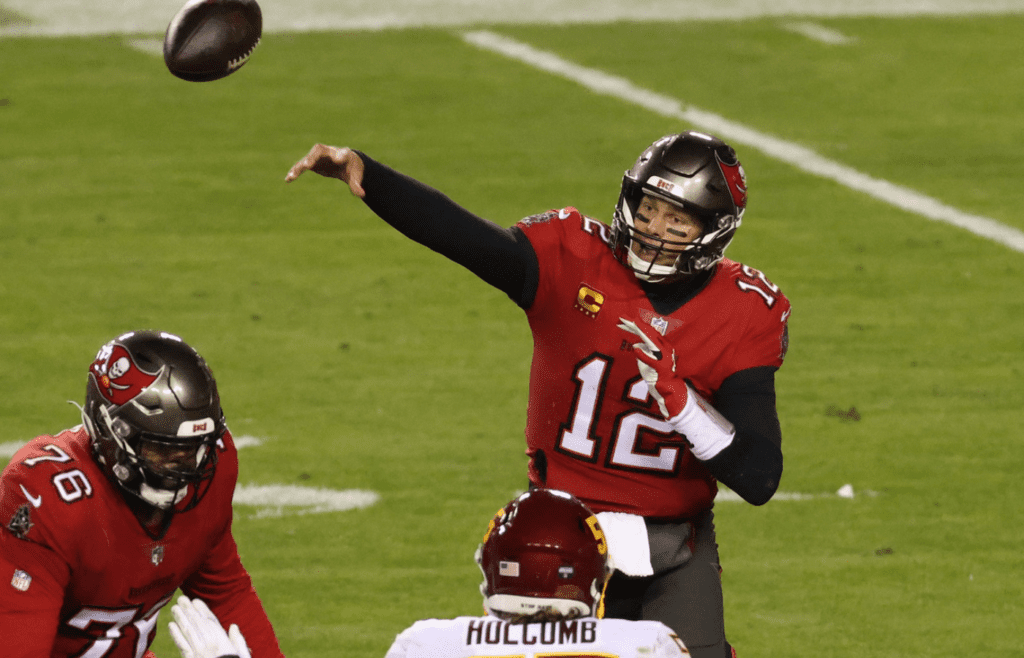 Jan 9, 2021; Landover, Maryland, USA; Tampa Bay Buccaneers quarterback Tom Brady (12) passes the ball against the Washington Football Team at FedExField. Mandatory Credit: Geoff Burke-Imagn Images