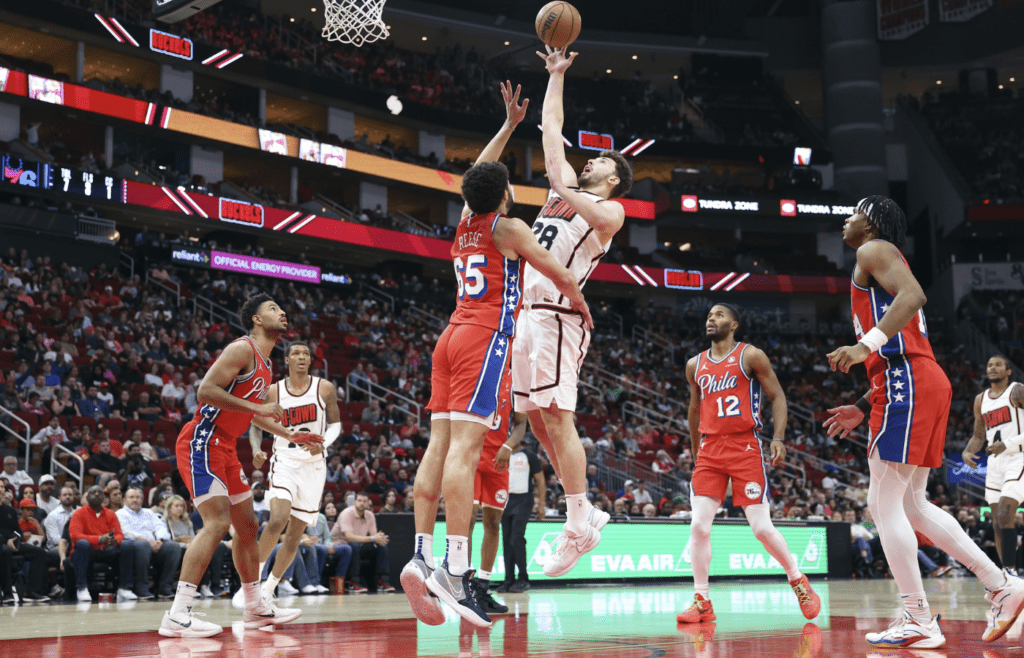 Mar 17, 2025; Houston, Texas, USA; Houston Rockets center Alperen Sengun (28) shoots the ball as Philadelphia 76ers forward Alex Reese (65) defends during the second quarter at Toyota Center. Mandatory Credit: Troy Taormina-Imagn Images