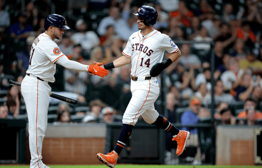 May 22, 2025; Houston, Texas, USA; Houston Astros second baseman Mauricio Dubon (14) is congratulated by Houston Astros designated hitter Yainer Diaz (21) after scoring a run against the Seattle Mariners during the third inning at Daikin Park. Mandatory Credit: Erik Williams-Imagn Images