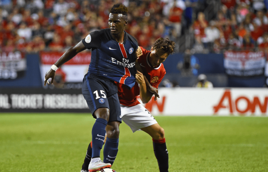 Jul 29, 2015; Chicago, IL, USA; Paris Saint-Germain forward Jean-Christophe Bahebeck (15) kicks the ball against Manchester United defender Matteo Darmian (36) during the second half at Soldier Field. Paris Saint-Germain defeats Manchester United 2-0. Mandatory Credit: Mike DiNovo-Imagn Images