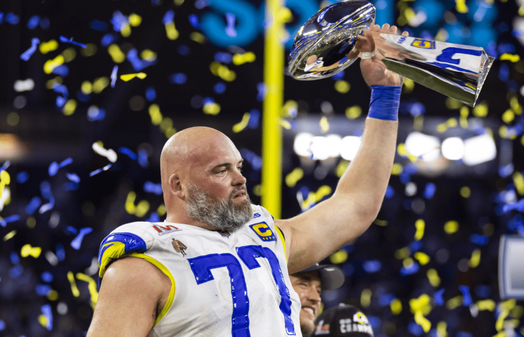 Feb 13, 2022; Inglewood, CA, USA; Los Angeles Rams offensive tackle Andrew Whitworth (77) celebrates with the Lombardi Trophy after defeating the Cincinnati Bengals during Super Bowl LVI at SoFi Stadium. Mandatory Credit: Mark J. Rebilas-Imagn Images