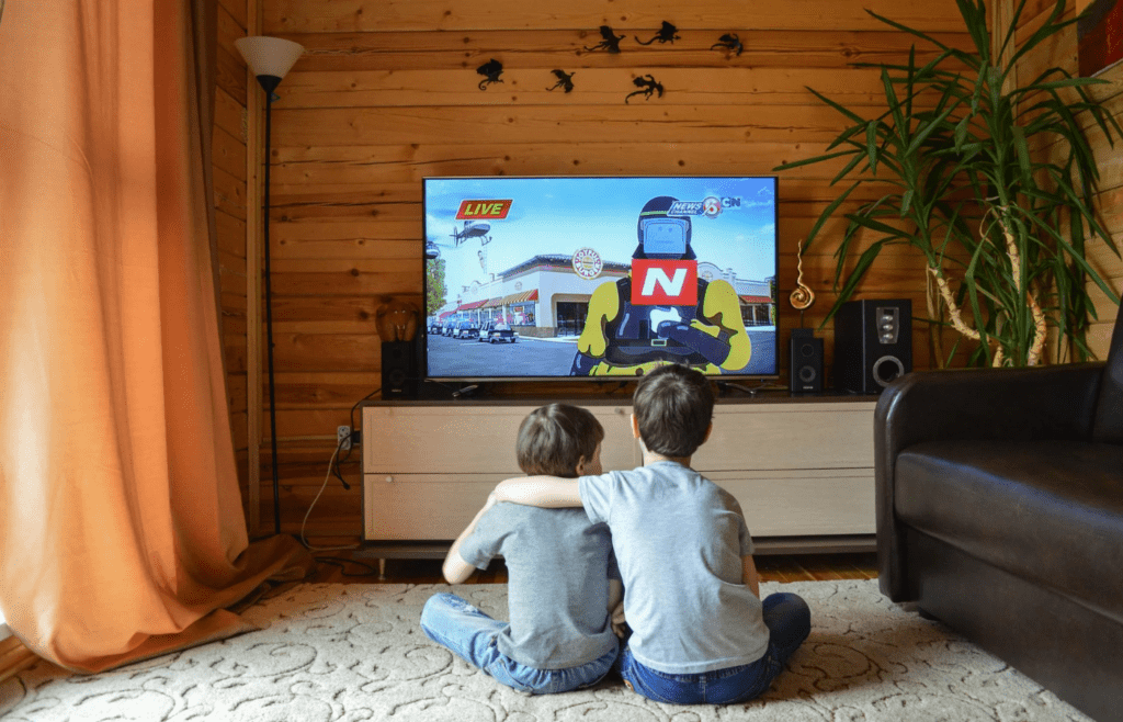 Two young boys watching Cartoon Network at home