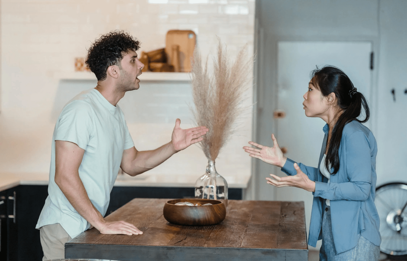 A couple mid-argument, one looking defensive