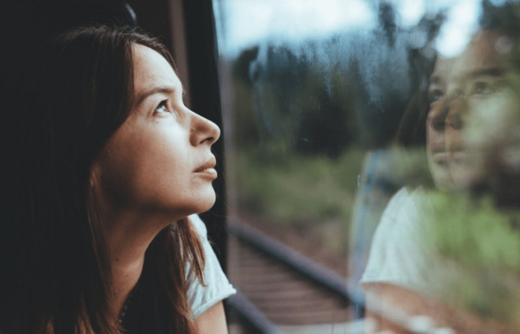 A person staring into space, looking unsure