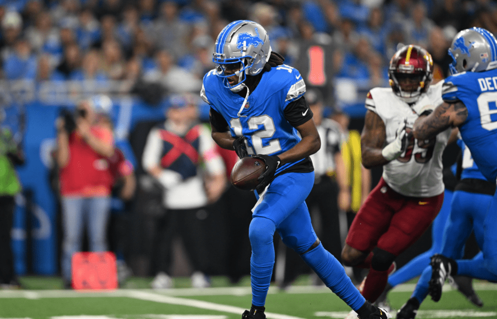 Jan 18, 2025; Detroit, Michigan, USA; Detroit Lions quarterback Teddy Bridgewater (12) hands the ball off during the second quarter against the Washington Commanders in a 2025 NFC divisional round game at Ford Field. Mandatory Credit: Lon Horwedel-Imagn Images