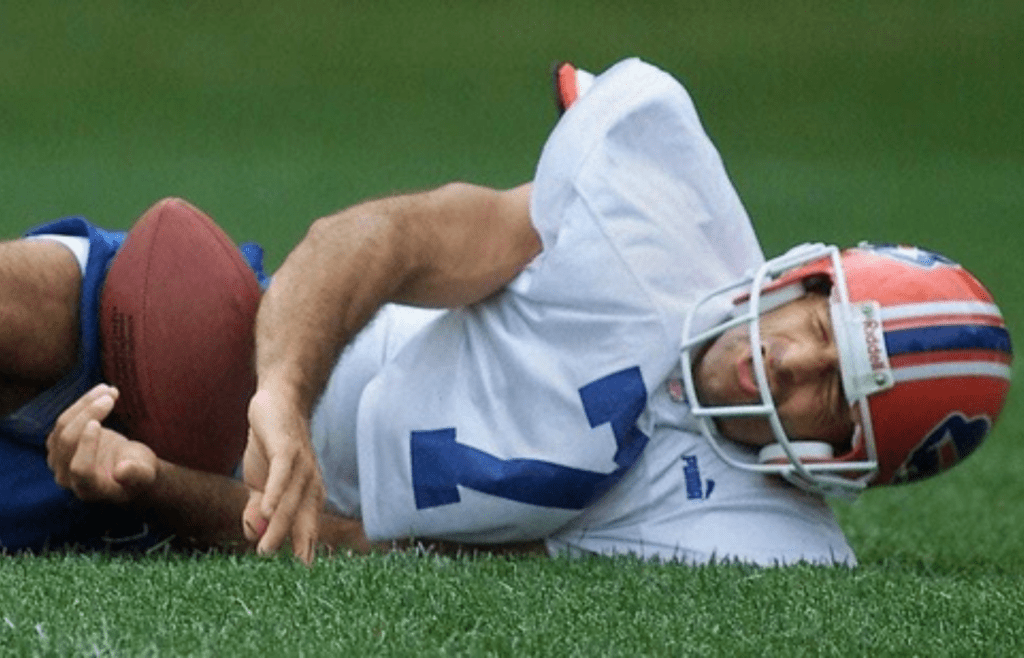 Doug Flutie on the ground at St. John Fisher College in pain after he suffered a groin injury during the Bills first training camp in Pittsford.