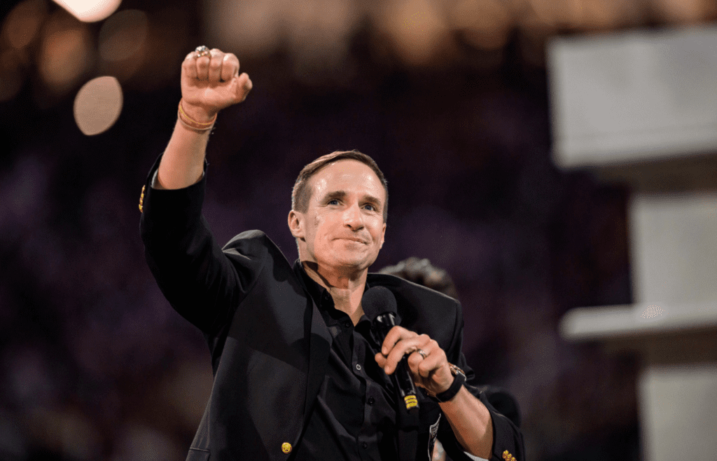 Oct 17, 2024; New Orleans, Louisiana, USA; New Orleans Saints retired quarterback Drew Brees (9) reacts during his hall of fame ceremony at halftime against the Denver Broncos at Caesars Superdome. Mandatory Credit: Matthew Hinton-Imagn Images