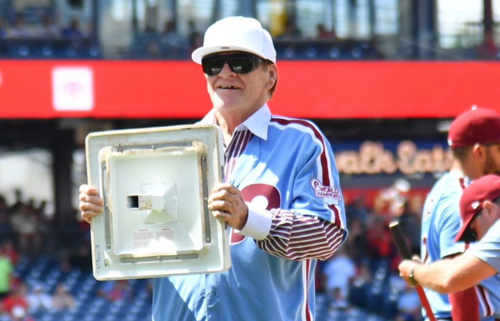 Aug 7, 2022; Philadelphia, Pennsylvania, USA; Philadelphia Phillies great Pete Rose acknowledges the crowd after he exchanged first base in between innings against the Washington Nationals at Citizens Bank Park. Mandatory Credit: Eric Hartline-Imagn Images