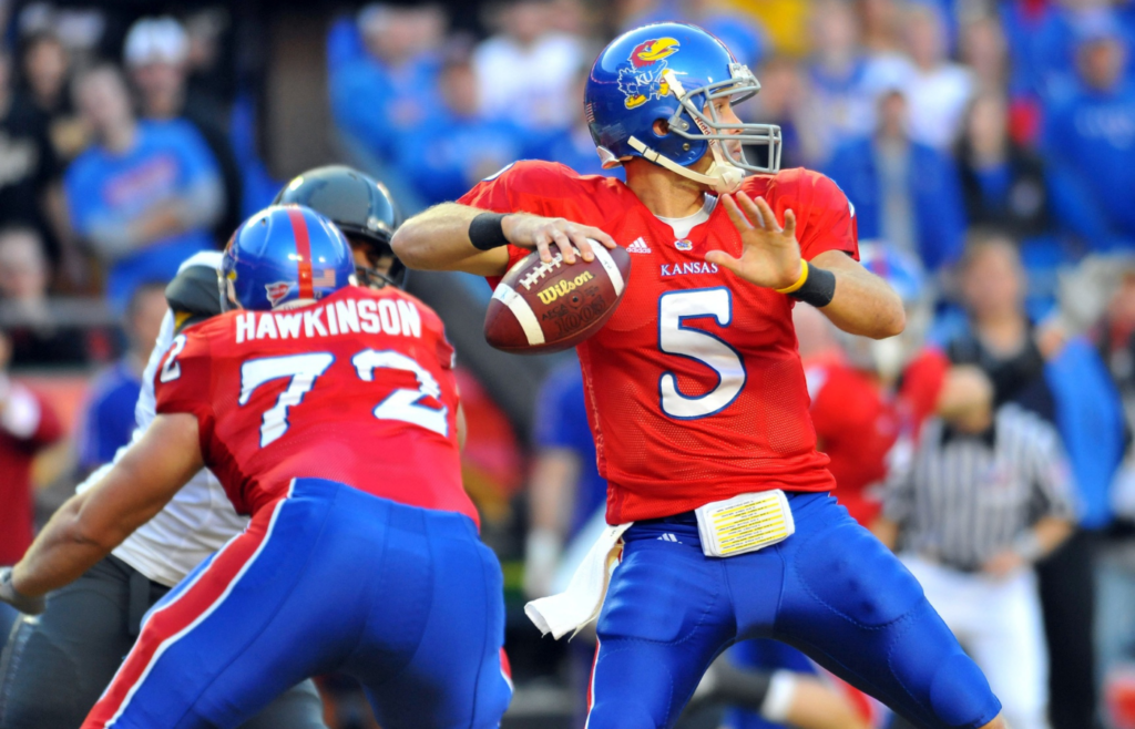 Nov 28, 2009; Kansas City, MO, USA; Kansas Jayhawks quarterback Todd Reesing (5) drops back to pass in the second quarter in the game against the Missouri Tigers at Arrowhead Stadium. Mandatory Credit: Denny Medley-Imagn Images