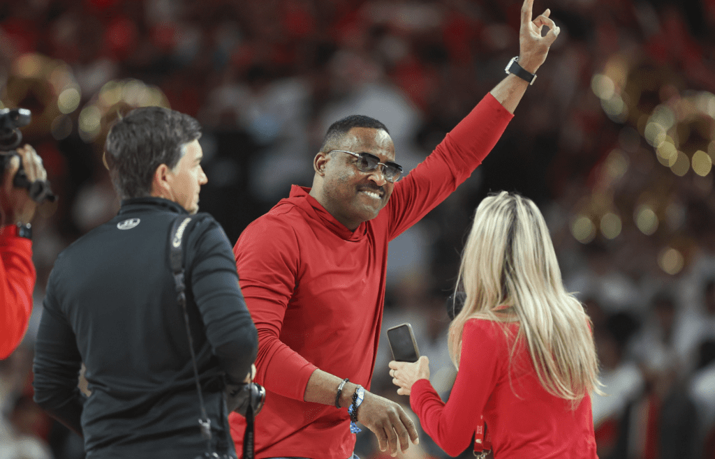 Feb 17, 2024; Houston, Texas, USA; Houston Cougars former quarterback and Heisman Trophy winner Andre Ware waves to fans before the game against the Texas Longhorns at Fertitta Center. Mandatory Credit: Troy Taormina-Imagn Images
