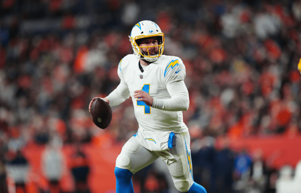 Jan 8, 2023; Denver, Colorado, USA; Los Angeles Chargers quarterback Chase Daniel (4) scrambles in the fourth quarter against the Denver Broncos at Empower Field at Mile High. Mandatory Credit: Ron Chenoy-Imagn Images