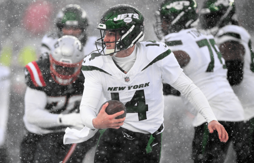 Jan 7, 2024; Foxborough, Massachusetts, USA; New York Jets quarterback Trevor Siemian (14) runs with the ball against the New England Patriots during the second half at Gillette Stadium. Mandatory Credit: Brian Fluharty-Imagn Images