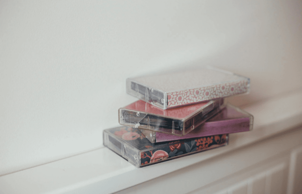 A stack of vintage CDs or cassette tapes
