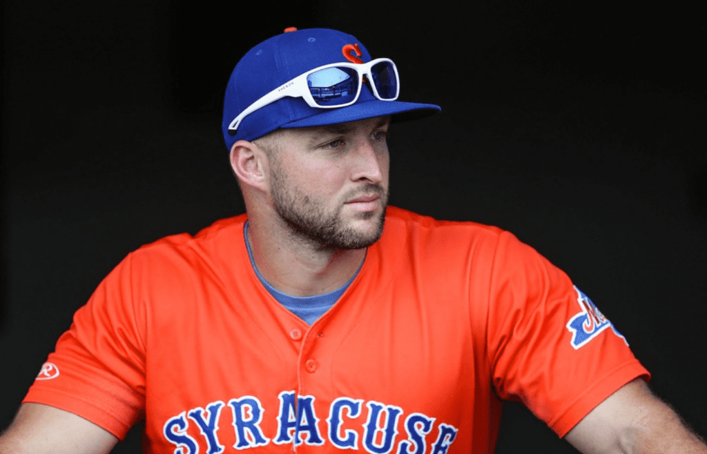 Syracuse Mets outfielder Tim Tebow, a former NFL quarterback, prepares to take on the Indianapolis Indians in the dugout at Victory Field on Monday, July 15, 2019. Syracuse Mets Outfielder Former Nfl Quarterback Tim Tebow At Indianapolis Indians Victory Field July 15 2019