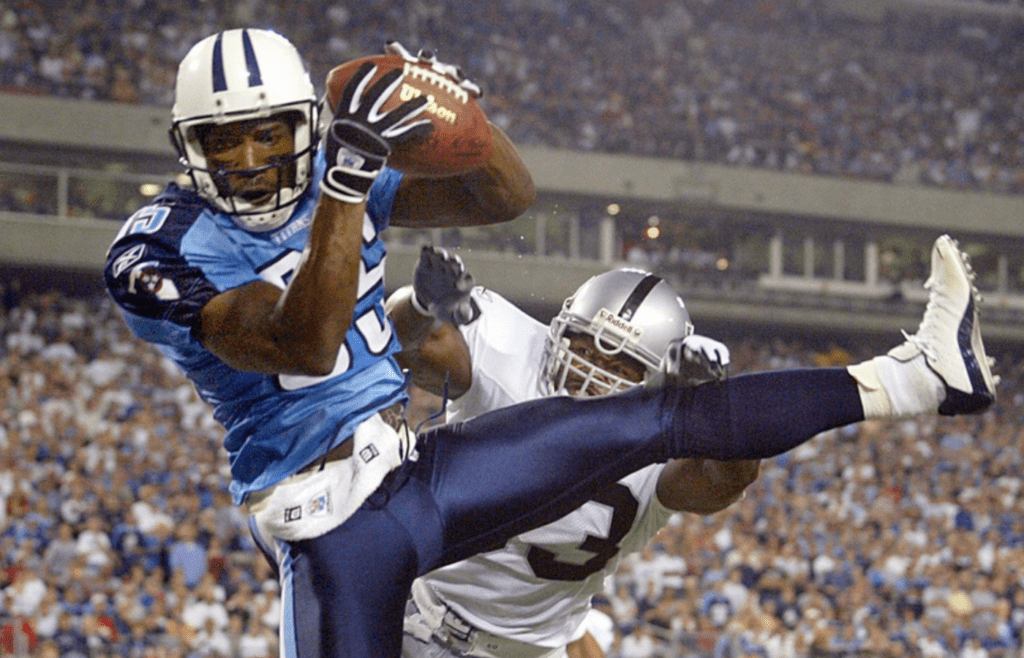 Tennessee Titans receiver Derrick Mason, front, catches a pass for a touchdown late in the game against the Oakland Raiders at the Adelphia Coliseum in Nashville on Sept. 7, 2003. The Titans won the home and season opener 25-20