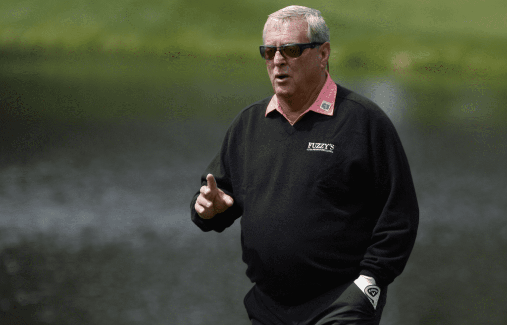 Apr 6, 2016; Augusta, GA, USA; Fuzzy Zoeller waves to the crowd as he walks to the 4th green during the Par 3 Contest prior to the 2016 The Masters golf tournament at Augusta National Golf Club. Mandatory Credit: Michael Madrid-Imagn Images